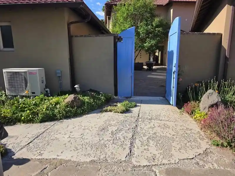 Before: a spalled, pitted concrete entry with a crumbling surface