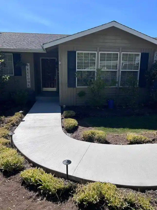 After: the curved front walkway resurfaced with a clean, even finish