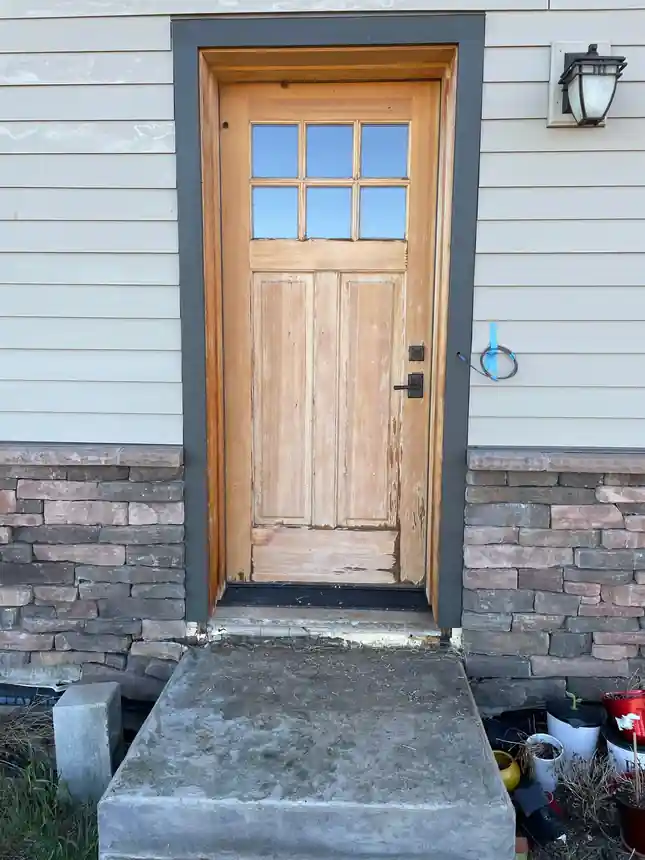Before: a concrete entry step in Zillah sitting low and rough below a wood front door