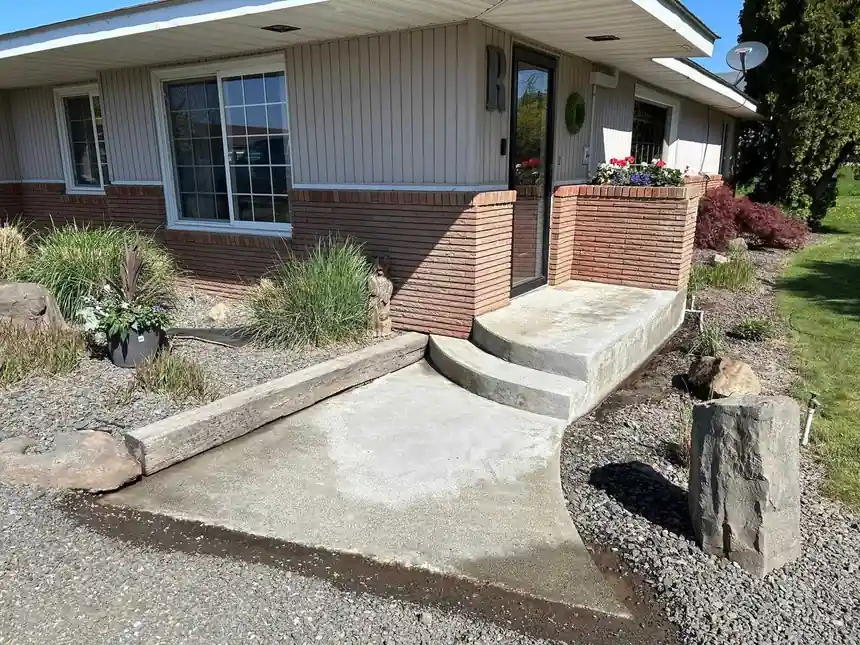Before: the worn front ramp and steps at a brick ranch house