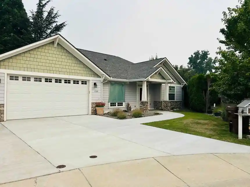 After: the garage driveway resurfaced with a clean, even surface