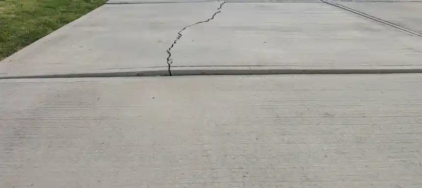 A wide concrete slab with a crack running across it and a joint beside it