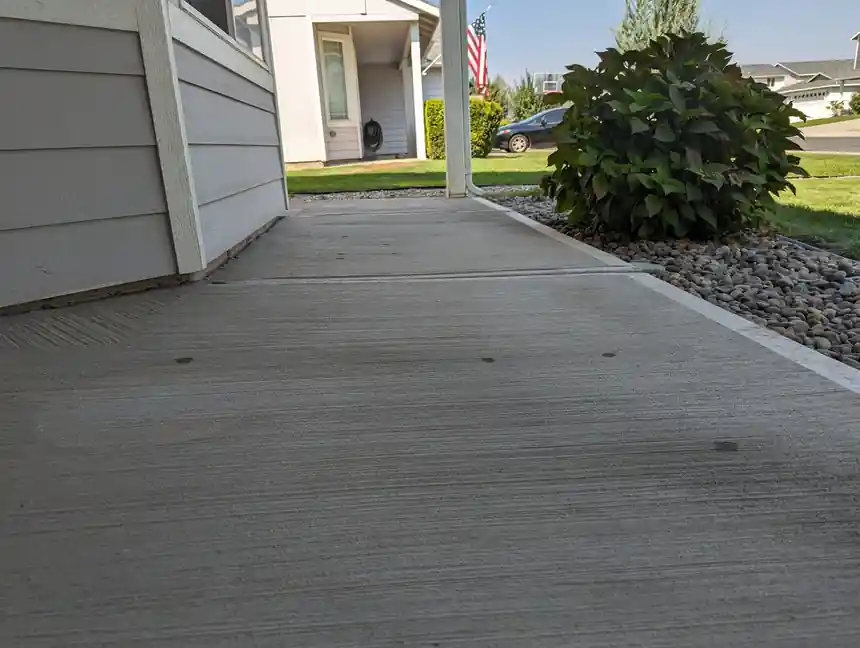 A side walkway along a house, lifted back level with the patio slab